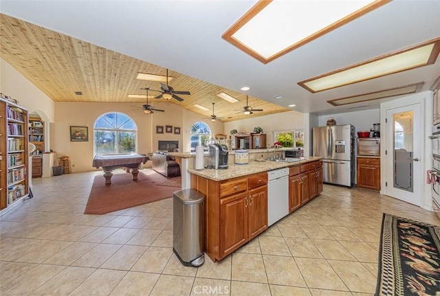 45544 Pine River Rd, Ahwahnee, CA 93601 - kitchen with light tile patterned floors, stainless steel fridge with ice dispenser, open floor plan, white dishwasher, and a sink