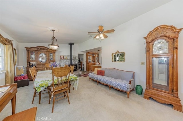 45544 Pine River Rd, Ahwahnee, CA 93601 - dining area with a wood stove, light carpet, ceiling fan, and visible vents