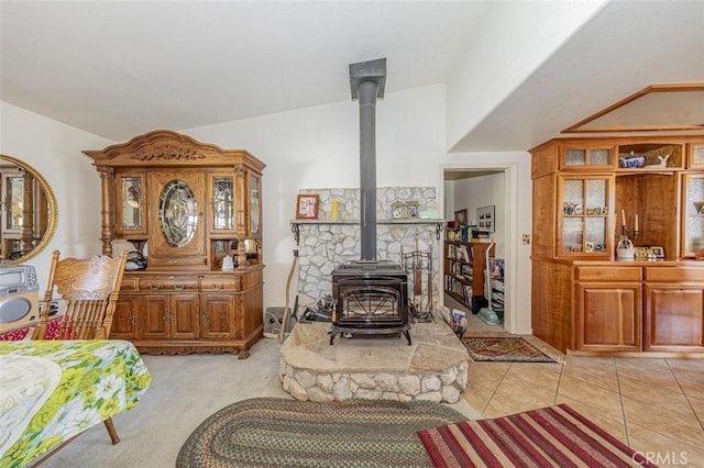 45544 Pine River Rd, Ahwahnee, CA 93601 - living area with a wood stove, light tile patterned floors, and lofted ceiling