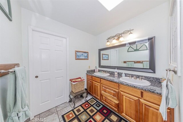 45544 Pine River Rd, Ahwahnee, CA 93601 - full bathroom featuring a sink and double vanity