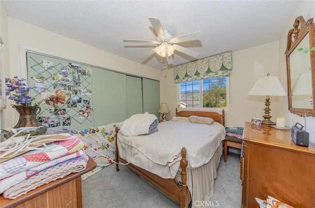 45544 Pine River Rd, Ahwahnee, CA 93601 - bedroom with light carpet, ceiling fan, a textured ceiling, and a closet