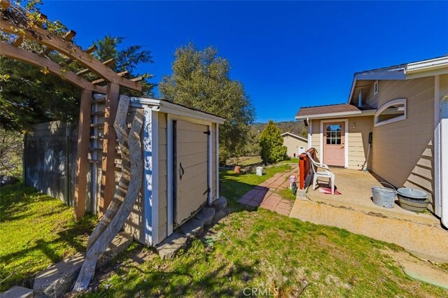 45544 Pine River Rd, Ahwahnee, CA 93601 - view of yard featuring an outbuilding, a patio, and a storage unit
