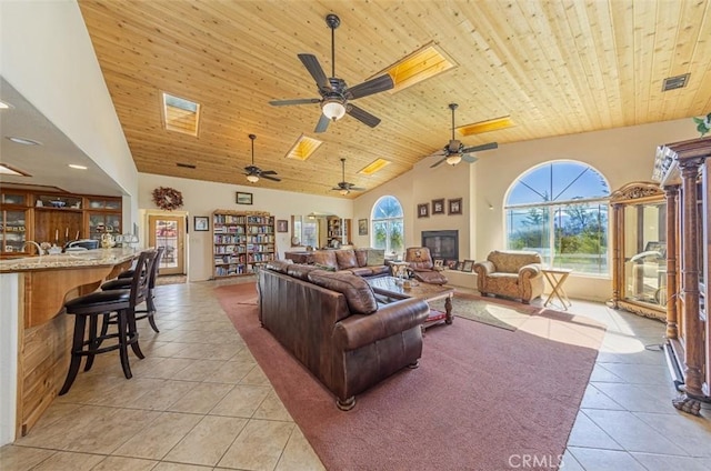 45544 Pine River Rd, Ahwahnee, CA 93601 - living area featuring light tile patterned floors, high vaulted ceiling, wooden ceiling, and visible vents