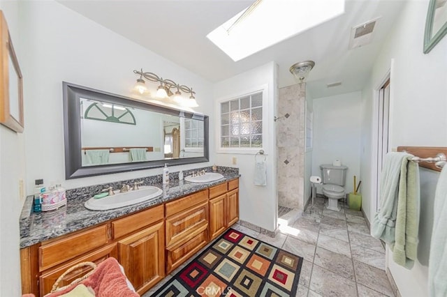 45544 Pine River Rd, Ahwahnee, CA 93601 - bathroom with a tile shower, double vanity, a skylight, and a sink