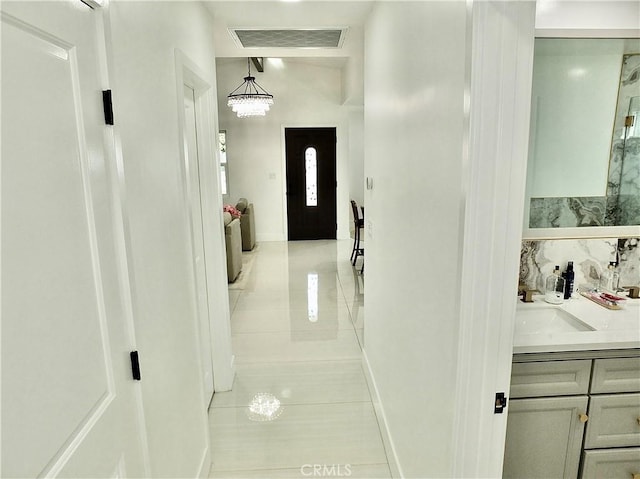 corridor with visible vents and a sink