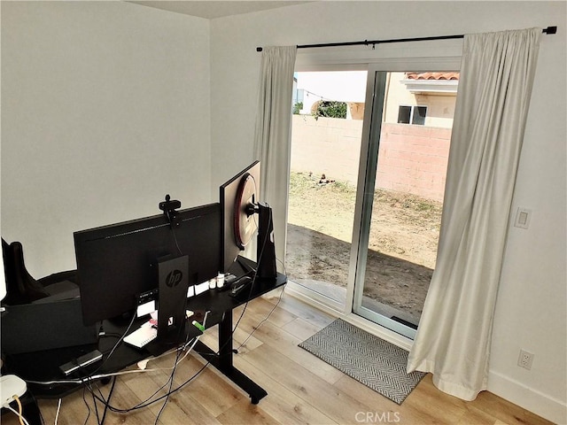 office space with light wood-style flooring and baseboards