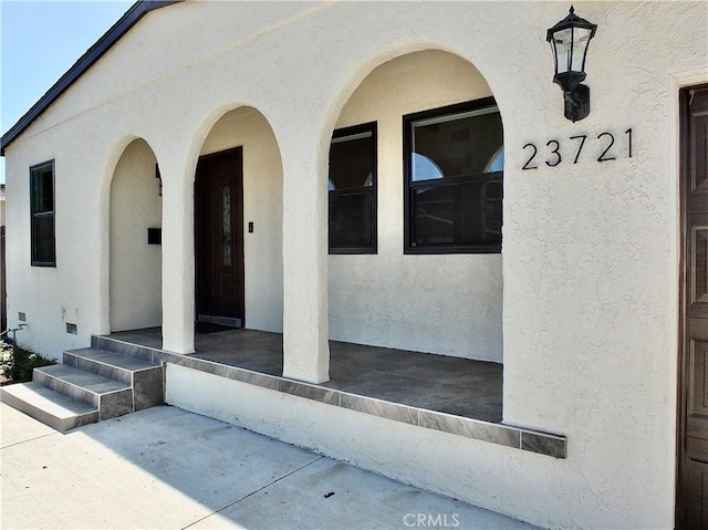 property entrance with stucco siding