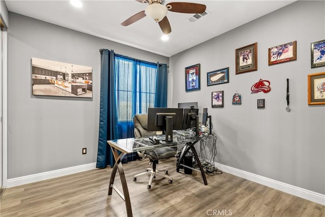 office area featuring wood finished floors, a ceiling fan, and baseboards