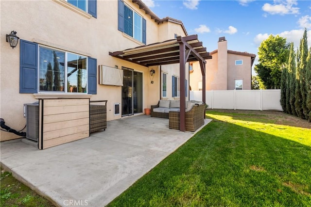 rear view of house with an outdoor living space, fence, stucco siding, a lawn, and a patio