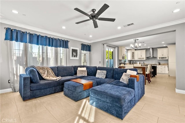 living room featuring visible vents, ceiling fan with notable chandelier, baseboards, and ornamental molding
