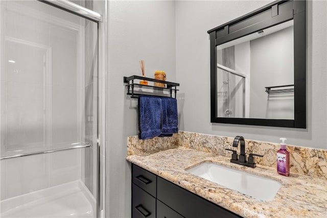 bathroom featuring a stall shower and vanity