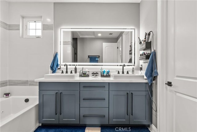 bathroom featuring a bathtub, double vanity, and a sink