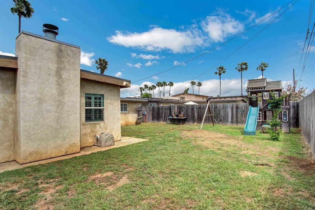 view of yard with a playground and a fenced backyard