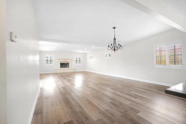 1331 Louden Ln, Imperial Beach, CA 91932 - unfurnished living room with wood finished floors, a chandelier, and a fireplace with raised hearth