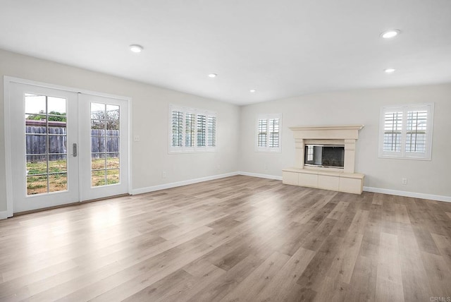 1331 Louden Ln, Imperial Beach, CA 91932 - unfurnished living room featuring light wood-style flooring, plenty of natural light, french doors, a fireplace, and recessed lighting