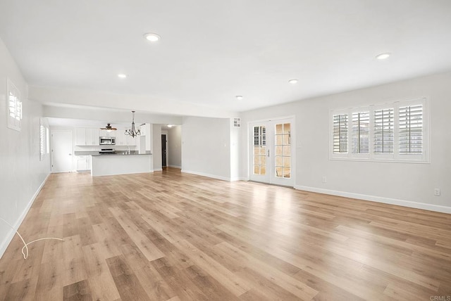 1331 Louden Ln, Imperial Beach, CA 91932 - unfurnished living room featuring light wood-style flooring, plenty of natural light, a chandelier, and recessed lighting