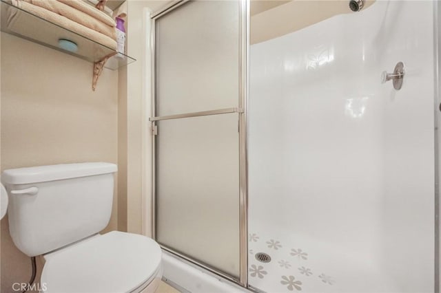 full bath with a shower stall and toilet