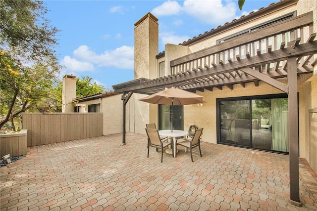 view of patio featuring outdoor dining area and a pergola