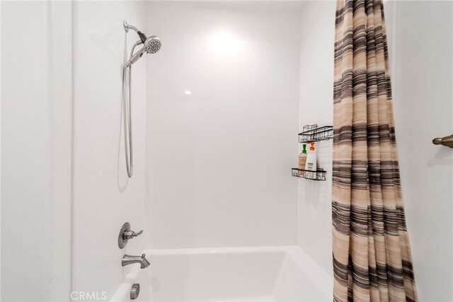 bathroom featuring shower / tub combo with curtain