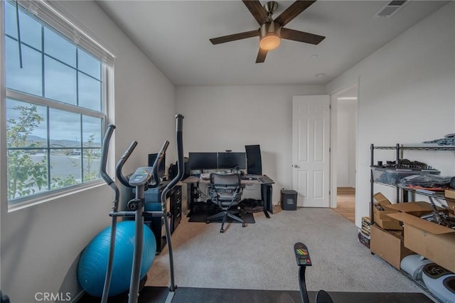 office area with carpet, visible vents, and ceiling fan