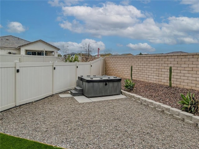 view of yard featuring a fenced backyard and a hot tub