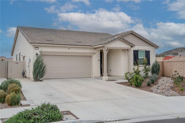 ranch-style house featuring a garage, fence, driveway, a tiled roof, and stucco siding