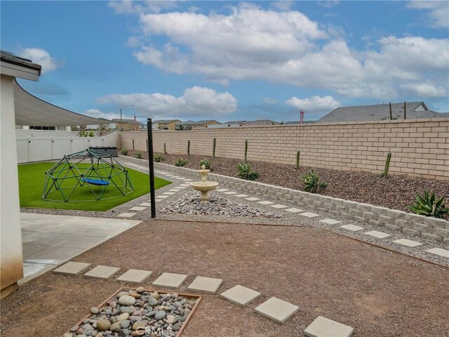 view of yard with a fenced backyard and a patio