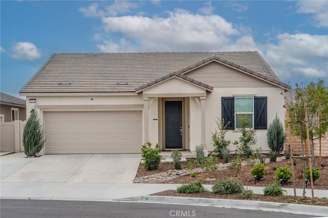 ranch-style home with a garage, a tile roof, concrete driveway, and stucco siding