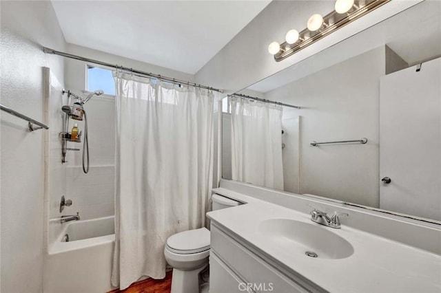 full bath with toilet, wood finished floors, vanity, and shower / bath combination with curtain