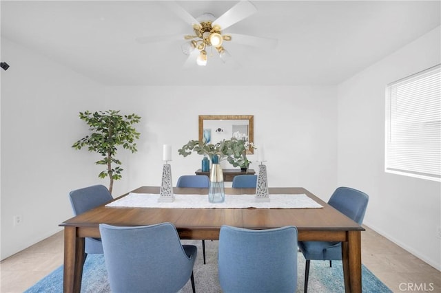 dining room featuring baseboards and ceiling fan