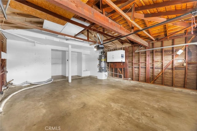 garage with water heater and a garage door opener