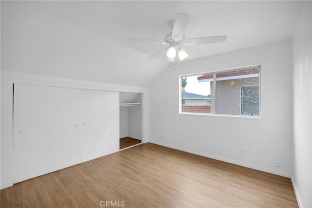 additional living space featuring a ceiling fan, lofted ceiling, wood finished floors, and baseboards