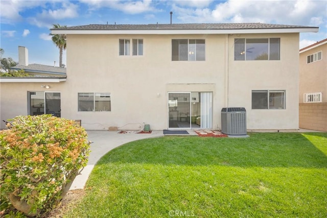 back of house featuring cooling unit, a patio, a yard, and stucco siding