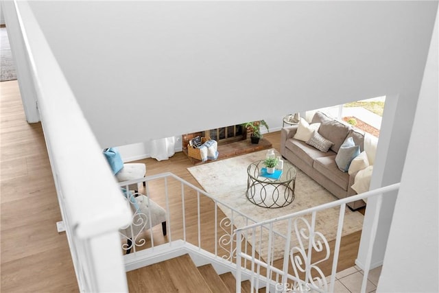 living room featuring stairs, wood finished floors, and baseboards