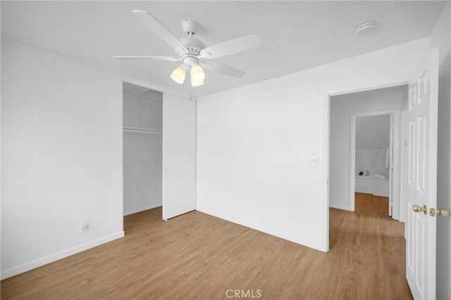 unfurnished bedroom featuring a ceiling fan, wood finished floors, a closet, and baseboards