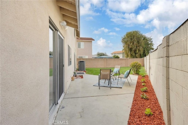 view of patio with central air condition unit and a fenced backyard