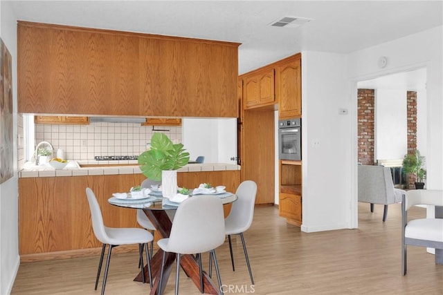 dining room with visible vents and light wood-style flooring