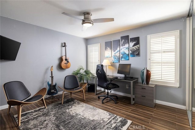 office area featuring a ceiling fan, dark wood-type flooring, and baseboards