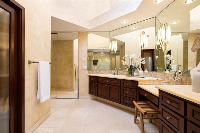 full bath with vanity, a shower stall, and tile patterned floors