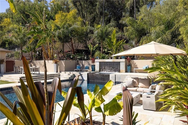 exterior space with a fenced in pool, an outdoor living space with a fire pit, a patio, and fence