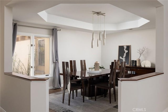 dining space featuring a tray ceiling