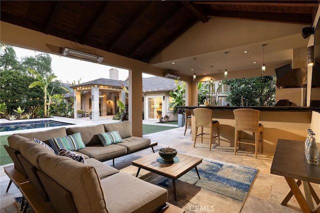 view of patio featuring outdoor lounge area, an outdoor pool, and exterior bar