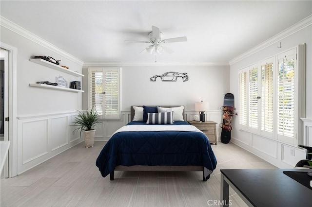 bedroom featuring a decorative wall, multiple windows, and crown molding