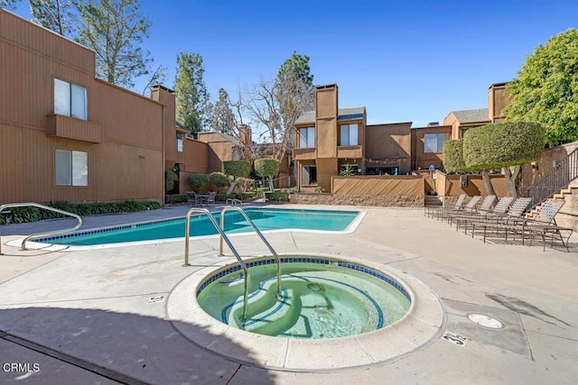 community pool featuring a community hot tub and a patio