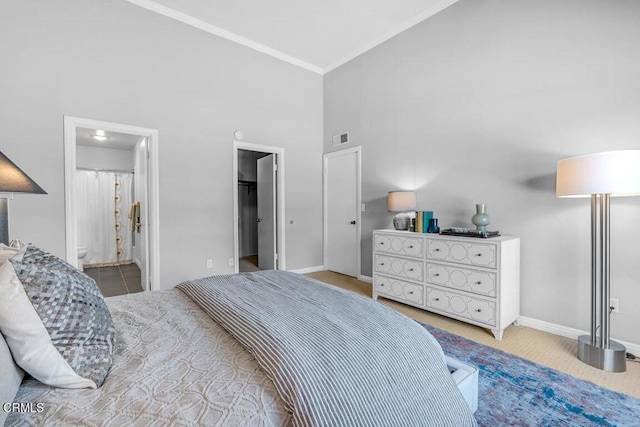 bedroom featuring visible vents, a spacious closet, ornamental molding, high vaulted ceiling, and baseboards