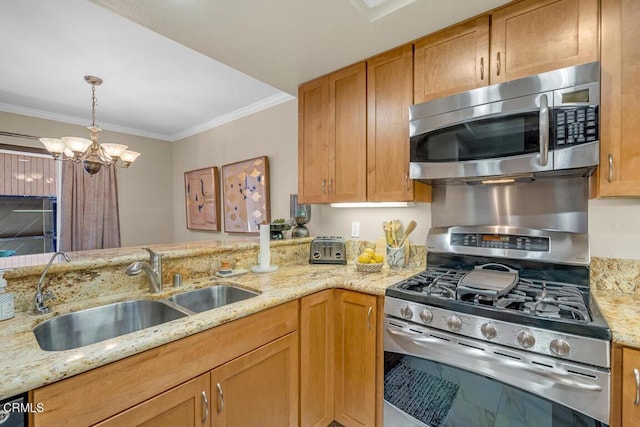 kitchen featuring pendant lighting, appliances with stainless steel finishes, ornamental molding, a sink, and light stone countertops