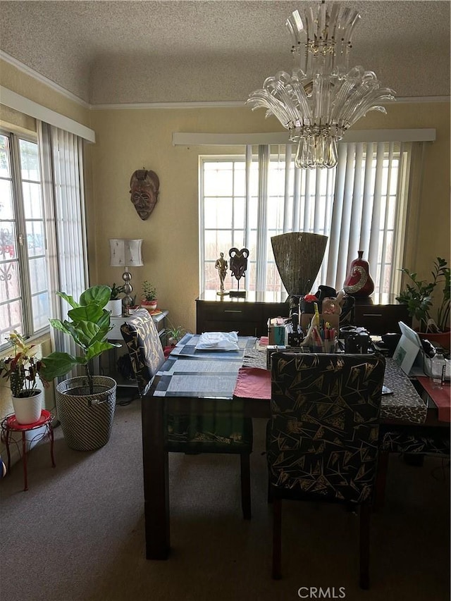 carpeted dining space featuring a textured ceiling, ornamental molding, a chandelier, and a wealth of natural light