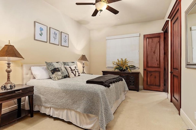 bedroom featuring a ceiling fan, light colored carpet, and baseboards