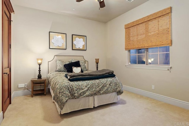 carpeted bedroom featuring ceiling fan and baseboards