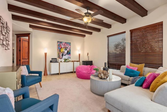 carpeted living room with a ceiling fan and beamed ceiling